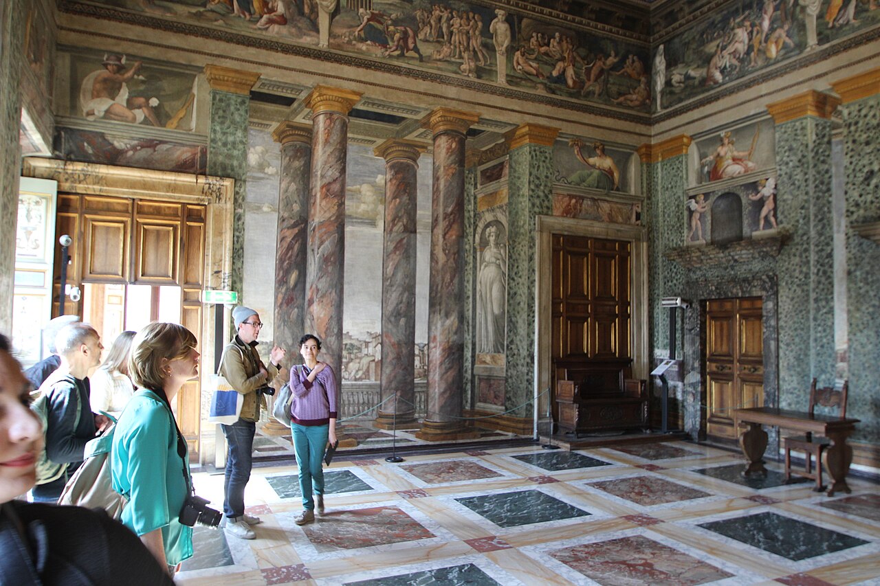 The Hall of Perspectives at Villa Farnesina, with painted columns framing landscape views.