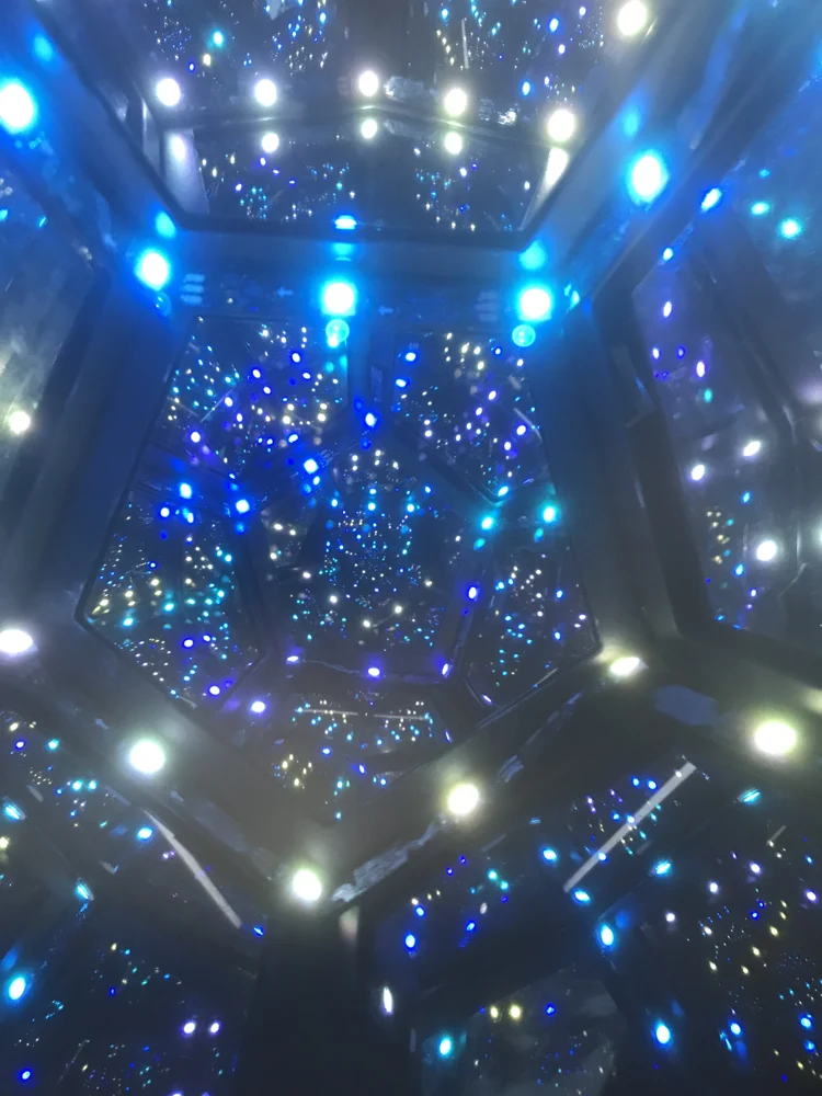 An illuminated mirrored dodecahedron creating repeating lights in multiple directions.